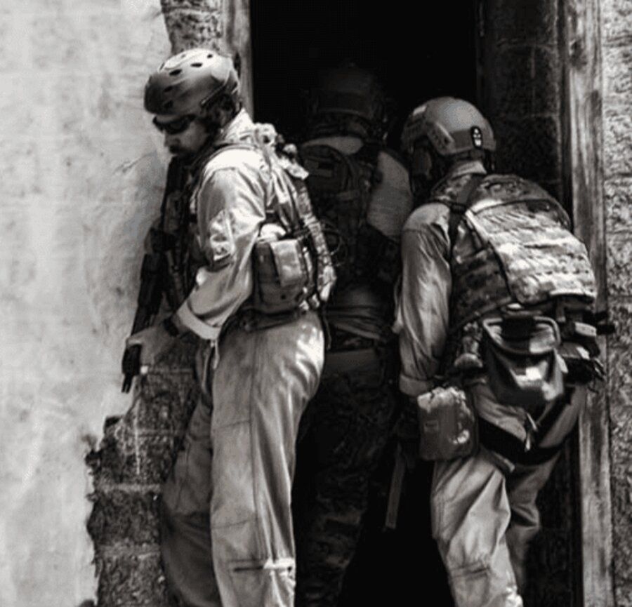 Tactical entry team moving through an Amidon live-fire shoot house doorway