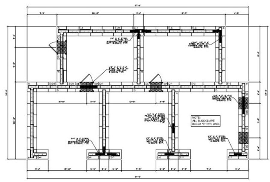 Engineering team reviewing a ballistic concrete shoot house floor plan