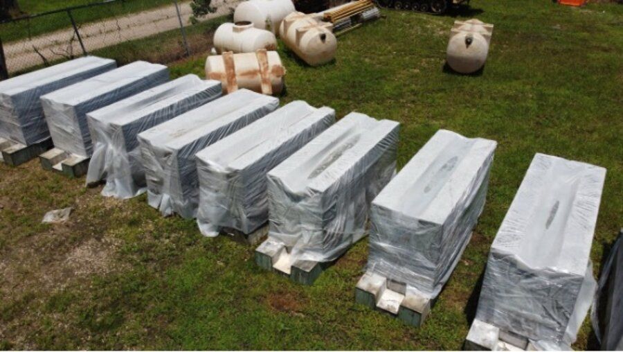 Precast Amidon ballistic concrete EOD pit panels shrink-wrapped and staged on pallets for delivery
