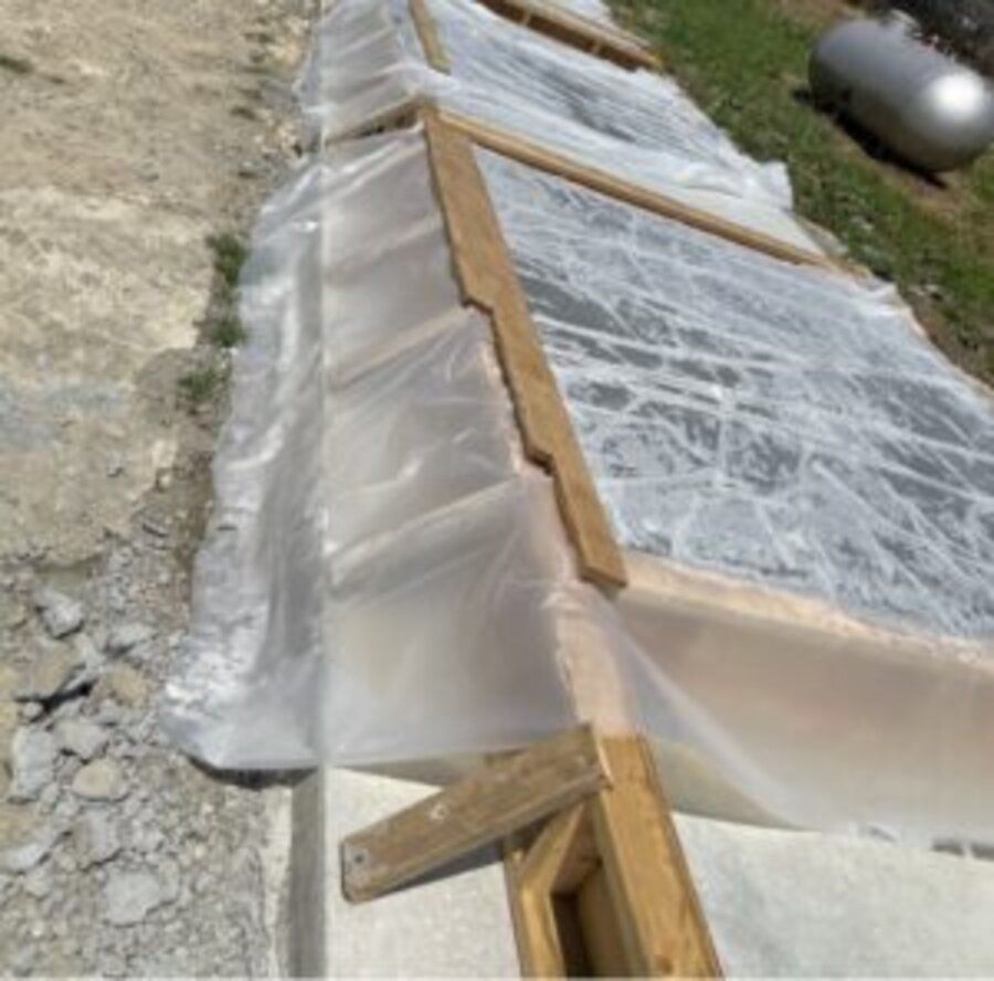 Close-up of precast ballistic concrete panels staged on wood blocking, ready for shipment