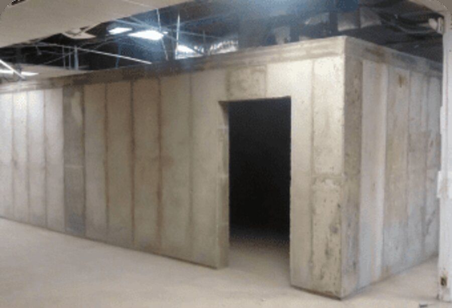 Interior of an Amidon Ballistic Concrete safe house with poured concrete walls and a reinforced doorway.