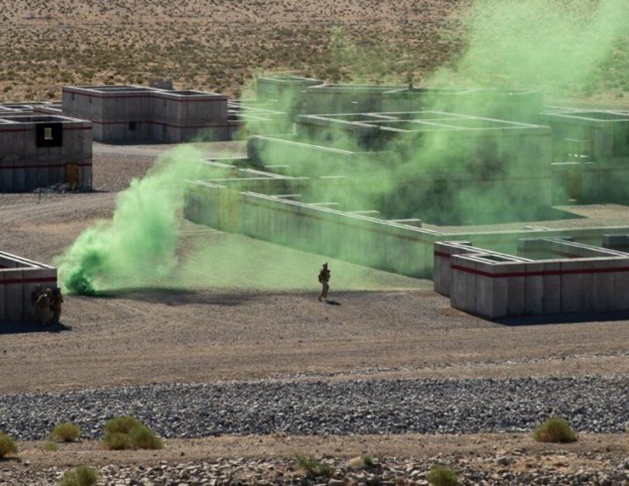 Aerial view of live-fire training buildings with green training smoke at Twenty Nine Palms, California