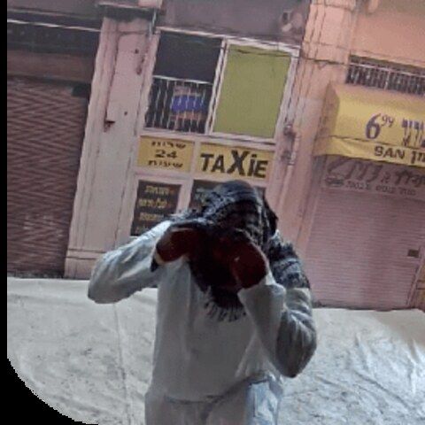 Trainee in a mock urban storefront scenario within an Amidon training complex