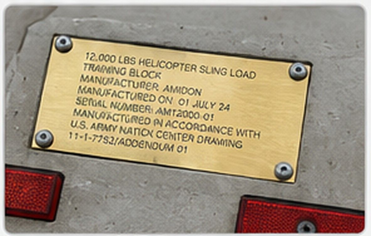 Close-up of an Amidon Sling Block brass identification nameplate and recessed reflector