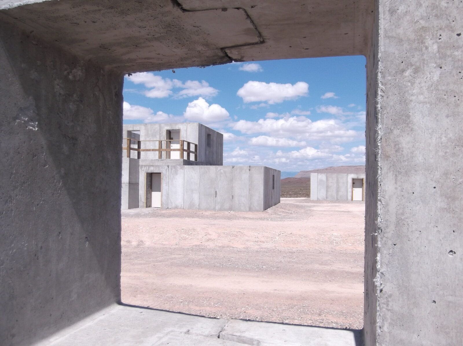 View through a doorway into an Amidon ballistic concrete shoot house training bay