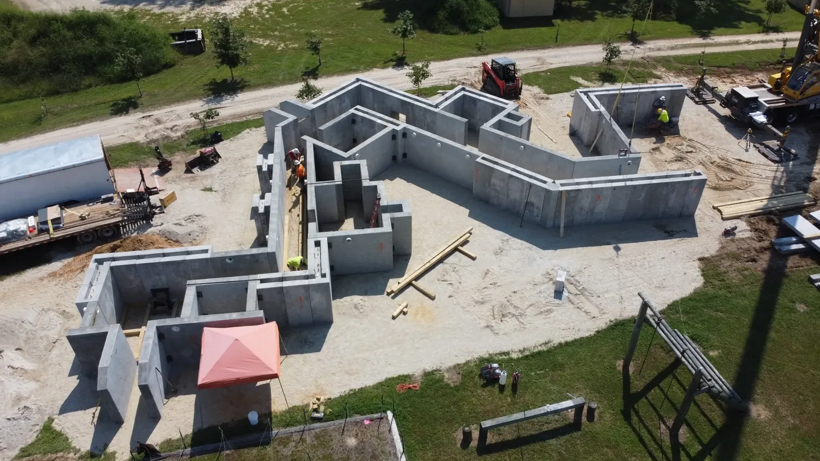 Full-height precast concrete routes being assembled at grade for an Amidon subterranean training complex