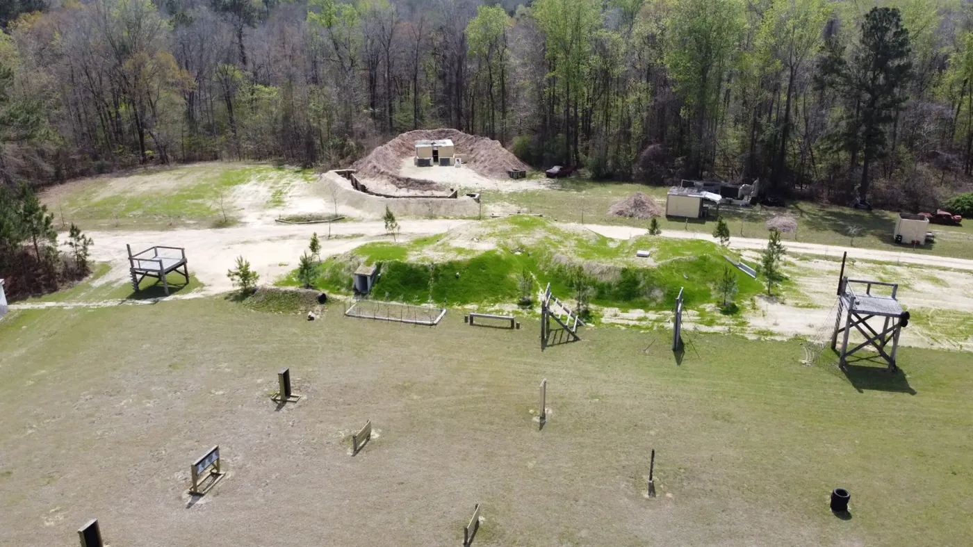 Completed subterranean training complex with optional earth berm and vegetation