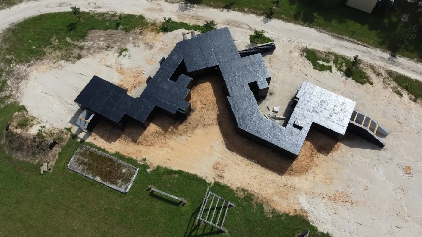 Aerial view of an enclosed and waterproofed modular subterranean training complex