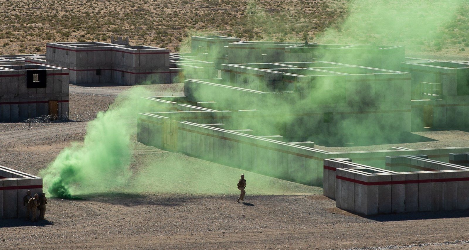 Live-fire training exercise with smoke concealment among Amidon Ballistic Concrete training structures