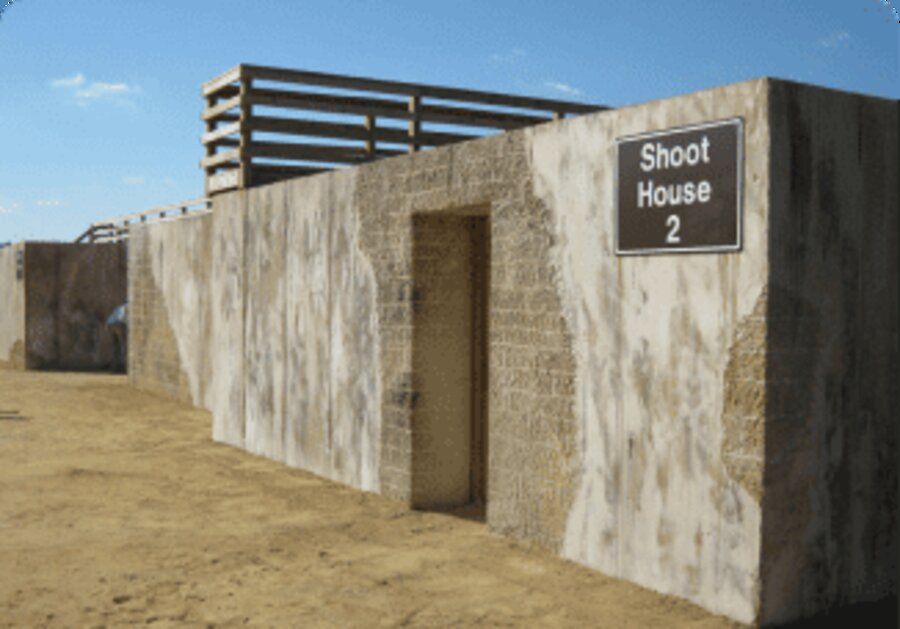 Labeled ballistic concrete shoot house structure built for a design-build urban training complex